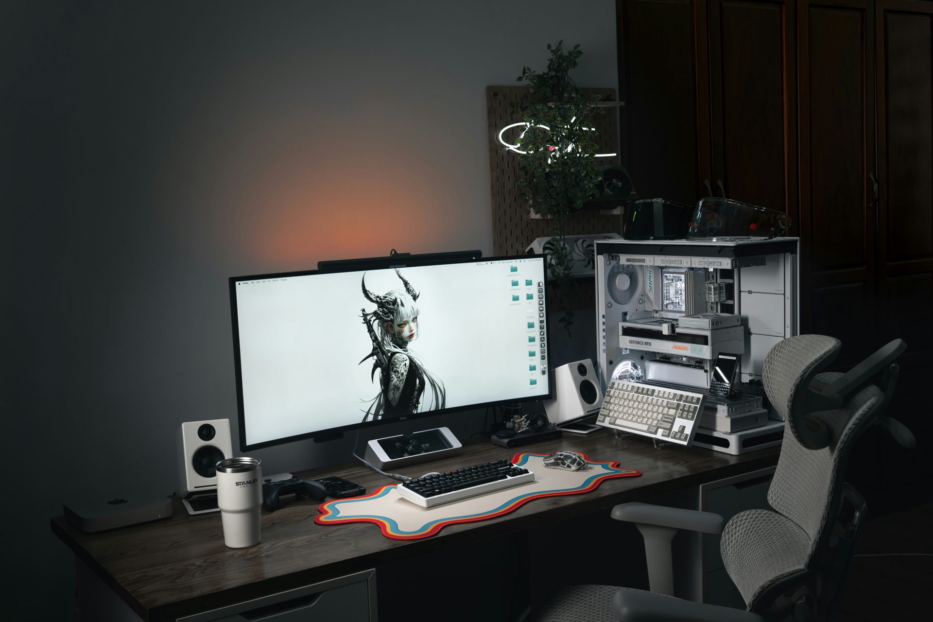 Modern computer setup with large monitor and gaming chair.